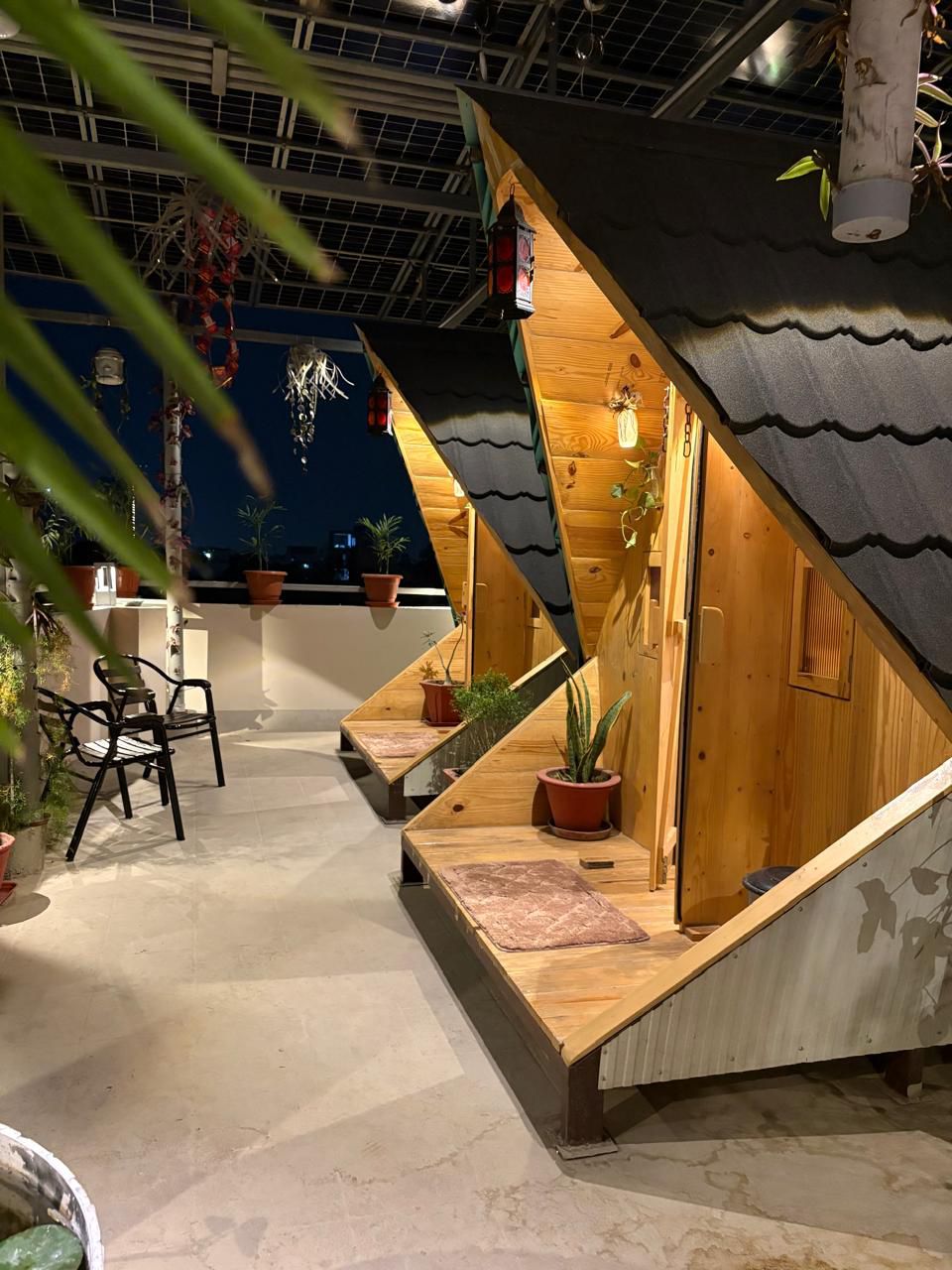 A peaceful terrace at dusk surrounded by greenery